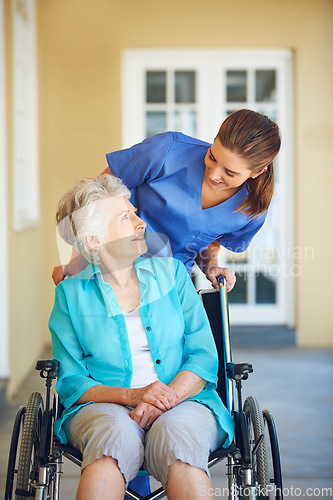 Image of Talking, nurse or happy old woman in wheelchair in hospital clinic helping an elderly patient for support. Trust, smile or healthcare medical caregiver speaking to a senior person with a disability