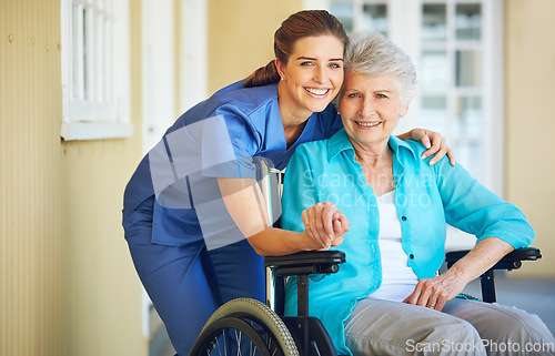 Image of Portrait of nurse, hugging or old woman in wheelchair in hospital helping a senior patient for support. Holding hands, happy smile or healthcare caregiver smiling with an elderly lady with disability