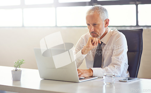 Image of Laptop, thinking and strategy with a business man in the office, working online to finish a project at his desk. Computer, idea and email with a mature male manager at work for company research