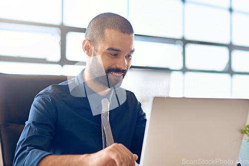 Image of Laptop, smile and strategy with a business man in the office, working online to finish a project at his desk. Computer, technology and email with a young male employee at work for company research