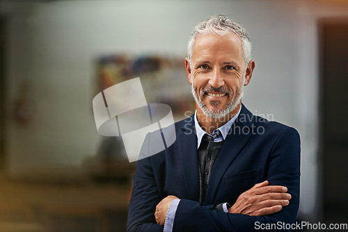 Image of Portrait, mindset and arms crossed with a business man in his office, looking happy about his company growth. Mission, vision and confidence with a senior male corporate manager standing at work