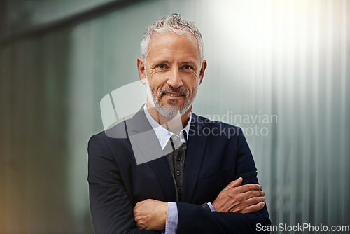 Image of Portrait, vision and arms crossed with a corporate man in his office, looking happy about his company growth. Mission, mindset and confidence with a senior male business manager standing at work