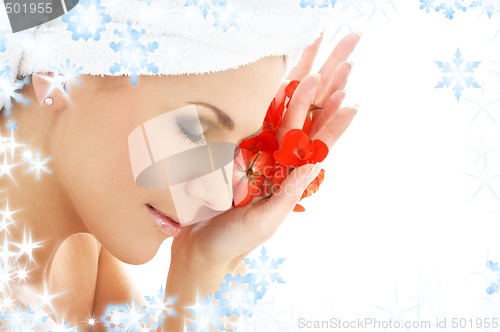 Image of happy woman with red flower petals