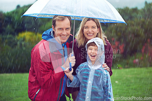 Image of Happy family, child and portrait in rain with umbrella in nature outdoor for fun, happiness and quality time. Man, woman and boy kid laughing for water drops or freedom while playing in winter