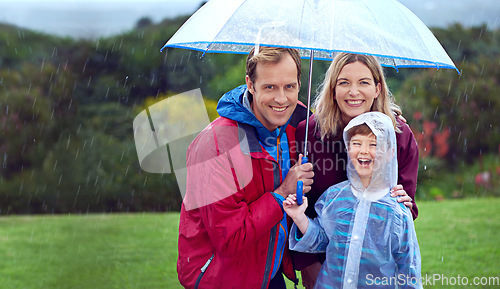 Image of Family, happy and portrait in rain with umbrella in nature outdoor for fun, happiness and quality time. Man, woman and boy child with protection for water drops with freedom while playing in winter