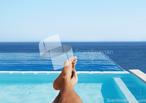 Image of POV, feet and man relax at a pool for travel and summer vacation at the sea by hotel and water. Barefoot, calm and traveling person outdoor at poolside holiday or rest at luxury resort in Maldives