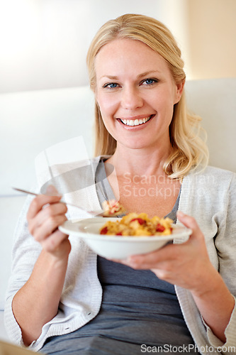Image of Happy woman, portrait smile and cereal for breakfast, morning meal or healthy diet in living room at home. Female person smiling with food bowl of wheat or corn flakes for health, nutrition or fiber