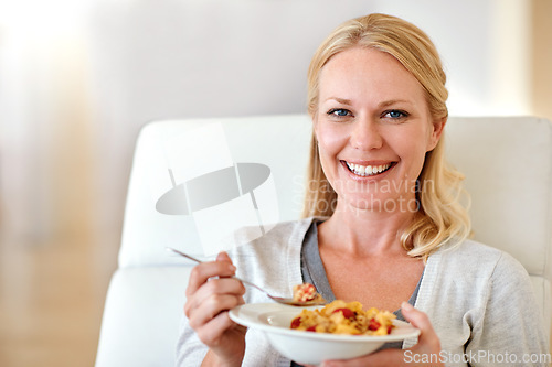 Image of Happy woman, portrait smile and cereal for healthy breakfast, meal or morning diet in living room at home. Female person smiling with food bowl of wheat or corn flakes for health, nutrition or fiber