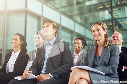 Image of Business, group and seminar listen at an agency with a smile in the audience to learn. Professional, listening and together at a conference to plan a project during a conversation in the company.