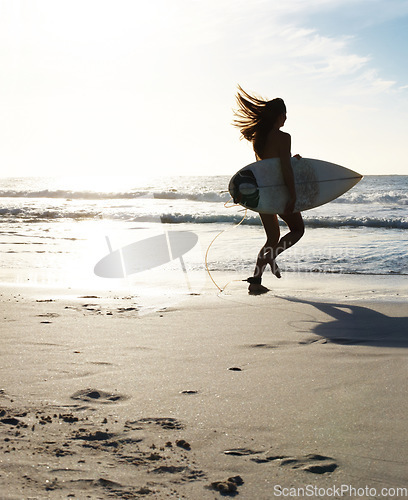 Image of Silhouette, woman surfer running on beach sand and sea, exercise outdoor with surfboard to surf in nature. Sports, shadow and sun with female person run to ocean waves for surfing and mockup space