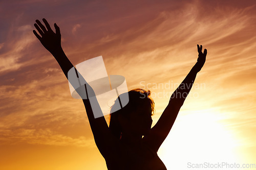 Image of Silhouette, sunset and woman open arms and freedom outdoor, orange sky with fresh air and celebrate life. Meditation, wellness and peace in nature with shadow, female person with healthy mindset