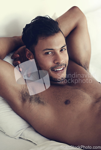 Image of Portrait, smile and morning with a sexy man in bed, shirtless after a rest to relax while ready to wake up. Face, happy and body with a handsome or sensual young male model lying topless in a bedroom