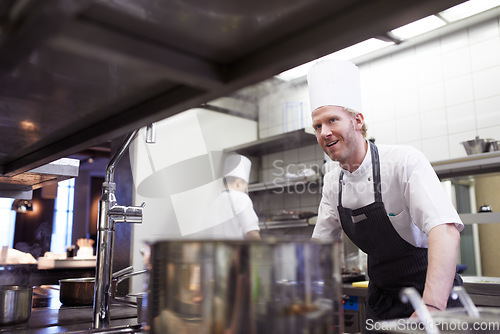 Image of Commercial, man and chef in a kitchen, service and order preparation for meal during dinner rush. Male person, restaurant and professional with planning, food industry and catering with hospitality