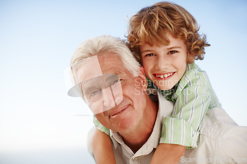 Image of Piggyback, face of grandfather with child and happy outdoors in blue sky. Portrait of family love, quality time and cheerful grandparent with young boy outside in nature for freedom or summer holiday