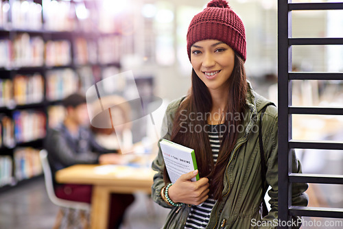 Image of Woman in portrait, student in library with book and study for exam with smile on university campus. Education, learning and academic development with female person holding textbook for knowledge