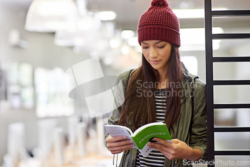 Image of Woman with book, student in library reading and study for exam or research on university campus. Education, learning and academic development with female person holding textbook for knowledge