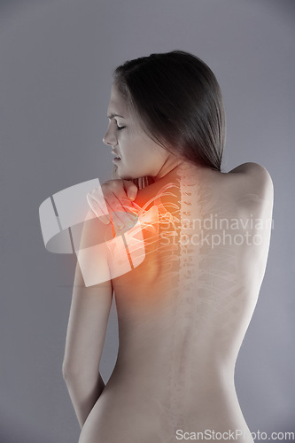 Image of Woman, shoulder pain or back injury in studio while frustrated, burnout or experience health problem. Female person massage red anatomy glow, spine accident or scoliosis backache on a grey background
