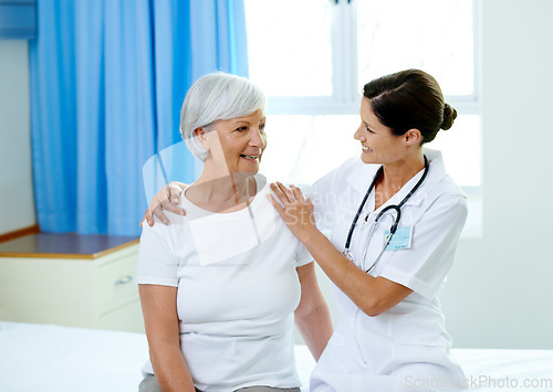 Image of Happy consultation, nurse and old woman in hospital room for advice, help and support at senior care clinic. Retirement caregiver, counselling and elderly patient with smile on bed with female doctor