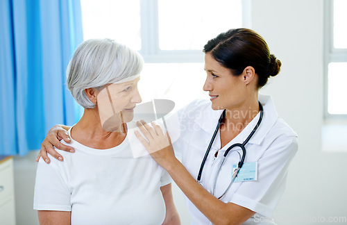 Image of Consultation, doctor and old woman in hospital for advice, help and support at senior care clinic. Retirement, counselling discussion and nursing home, happy elderly patient sitting on bed with nurse