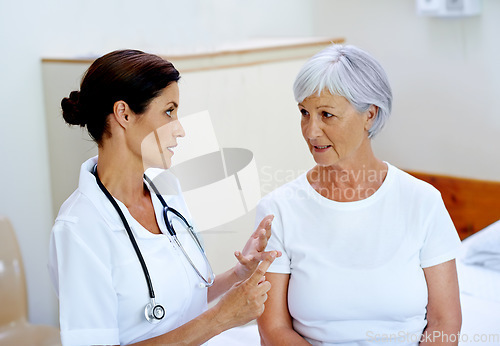 Image of Advice, female doctor and old woman in nursing home for results, help and support from senior care clinic. Retirement, discussion and medical feedback for elderly patient sitting on bed with nurse.