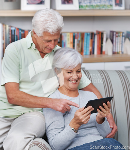 Image of Senior couple, tablet and home on couch for social media, online news app and reading ebook. Happy old man, elderly woman and digital technology for subscription show, internet connection and website