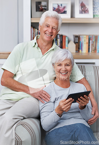 Image of Portrait, senior couple and smile with tablet, sofa and home for social media, online news app and ebook. Happy old man, woman and digital technology for subscription, website and internet connection