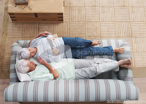 Image of Top view, senior couple and sofa with tablet, social media, online news app and ebook in lounge. Happy old man, woman and relax with digital technology, subscription or website on internet connection