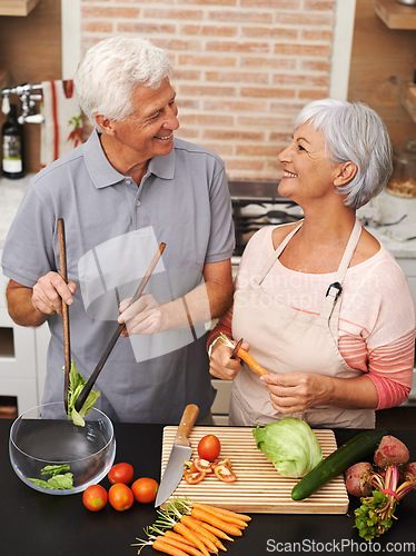 Image of Cooking, health and smile with old couple in kitchen for salad, love and nutrition. Happy, help and retirement with senior man and woman cutting vegetables at home for food, dinner and recipe