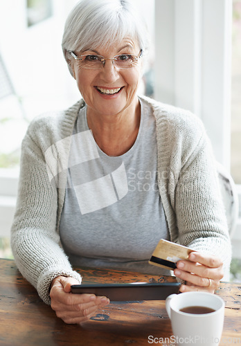 Image of Happy senior woman, tablet and credit card for online shopping, payment or banking on table at home. Portrait of excited elderly female shopper on technology for ecommerce, purchase or bank app