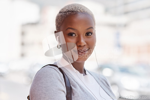 Image of Portrait, smile and black woman with earphones, city and listening to music for motivation. Face, female person and girl outdoor, headphones and streaming sounds with confidence, audio and podcast