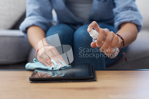 Image of Woman, hands and cleaning tablet screen with spray and cloth, disinfectant and chemical detergent with closeup. Cleaner, antibacterial liquid or sanitizer, female person clean tech gadget and hygiene