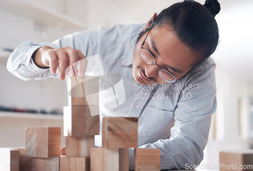 Image of Building block, business and man with plan, vision challenge game and design innovation for balance at a startup. Engineering, architecture and designer with wood blocks for problem solving ideas.