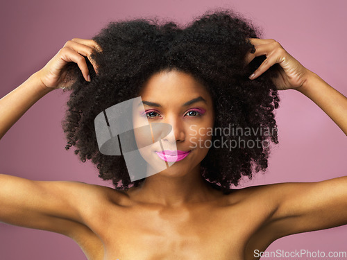 Image of Face, hair care and black woman with afro in studio isolated on a pink background with eyeshadow. Hairstyle portrait, lipstick makeup and African female model with salon treatment for cosmetics.