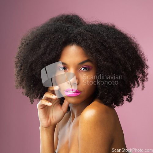 Image of Face, hair care and serious black woman with makeup in studio isolated on a pink background for skincare. Hairstyle portrait, cosmetics and African female model with salon treatment for afro beauty.