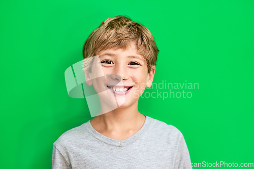 Image of Portrait, green screen and boy with a smile, mockup and confident kid against a studio background. Face, male child and young person with happiness, relax and casual with development, happy and joy