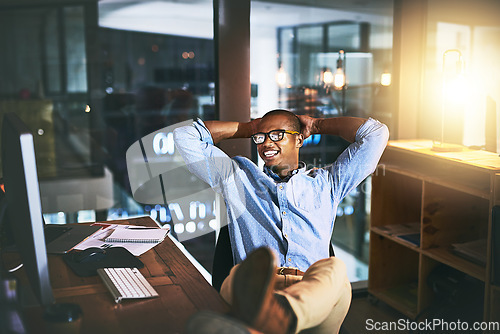 Image of Night, business and man relax, employee and creative with startup success, company development and computer. Male person, entrepreneur or consultant working late, chilling or technology in the office