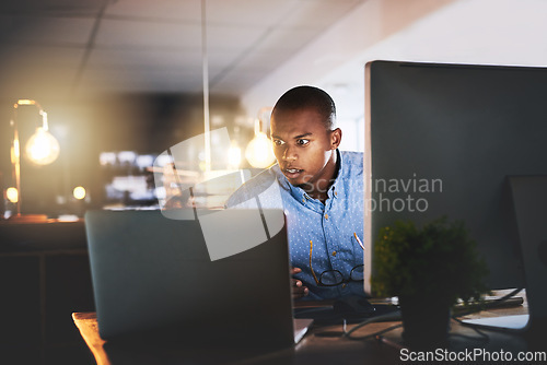 Image of Business stress, man working and computer at night with office typing and project web research. African male worker, technology and coding for website management for company with tech and anxiety