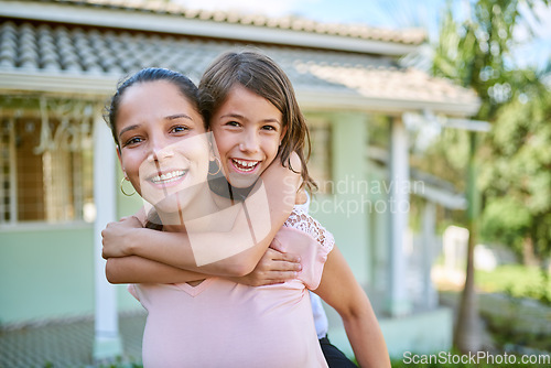 Image of Portrait, children and a piggyback mother with her daughter outdoor in the garden of their home together. Face, smile and love with a happy woman carrying her female child outside in the backyard