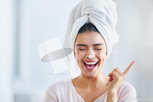 Image of Happy woman, head towel and cream on nose for cosmetics, beauty and dermatology. Female person, face and laughing with facial lotion after shower for healthy shine, glow or aesthetic skincare at home