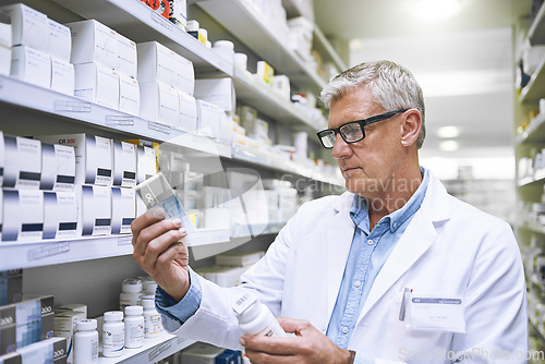 Image of Pharmacy, medicine and search with man in store for label reading, inspection and inventory. Medical, healthcare and pills with mature male pharmacist in clinic for expert, wellness and product check