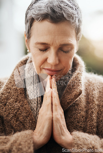 Image of Senior woman is praying, hands with worship and religion, God with peace, gratitude and faith outdoor. Spiritual female person in nature with face, eyes closed and prayer for guidance and blessing