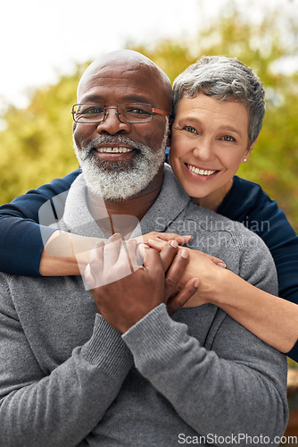 Image of Portrait, park or senior couple with hug, interracial or romantic with bonding, marriage or relationship. Face, mature black man or elderly woman embrace, retirement or partners with romance or love
