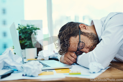 Image of Man, tired and sleeping on office desk with burnout, fatigue and overworked business employee with glasses, documents and laptop. Businessman, lawyer and exhausted sleep in company workplace
