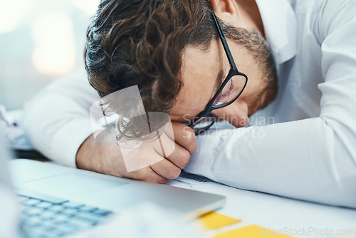 Image of Overworked, tired and man sleeping on desk with burnout, fatigue and business employee with glasses, papers and laptop sleep in office. Businessman, lawyer and exhausted in company workplace