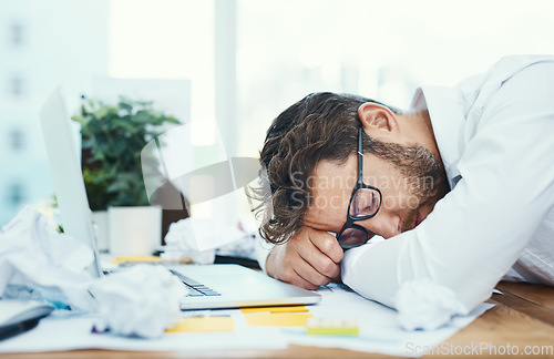 Image of Tired, man and sleeping on office desk with burnout, fatigue and overworked business employee with glasses, documents and laptop. Businessman, lawyer and exhausted sleep in company workplace