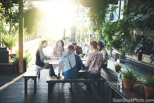 Image of Staff, group and meeting at a coffee shop, planning and startup success with brainstorming, creative ideas and conversation. Team, cafe or business people with teamwork, creativity and design project