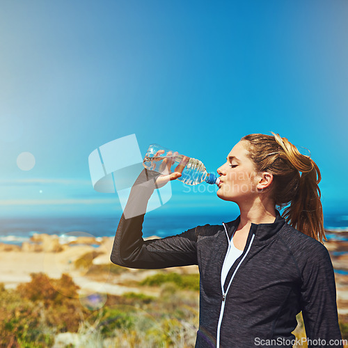 Image of Woman drink water, health and fitness with blue sky, athlete outdoor with hydration and mockup space. Exercise at beach, female person drinking h2o from bottle with workout and break from training