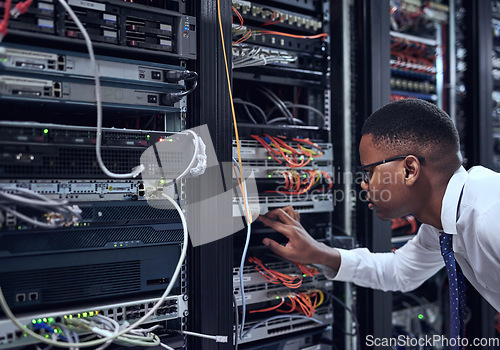 Image of Black man, IT technician and server room for cyber security, data or network storage inspection. African male person or networking administrator checking system, cables or installation at datacenter