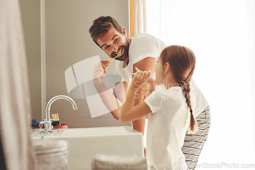 Image of Dental care, father with daughter brush their teeth and in bathroom of their home. Oral hygiene routine, parent with child use toothbrush for health and wellness mouth protection in the morning