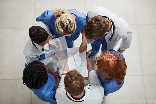 Image of Above, doctor group and paperwork in a hospital and clinic with teamwork and collaboration. Medical team, nurse and healthcare workers with research paper and meeting in a circle with document